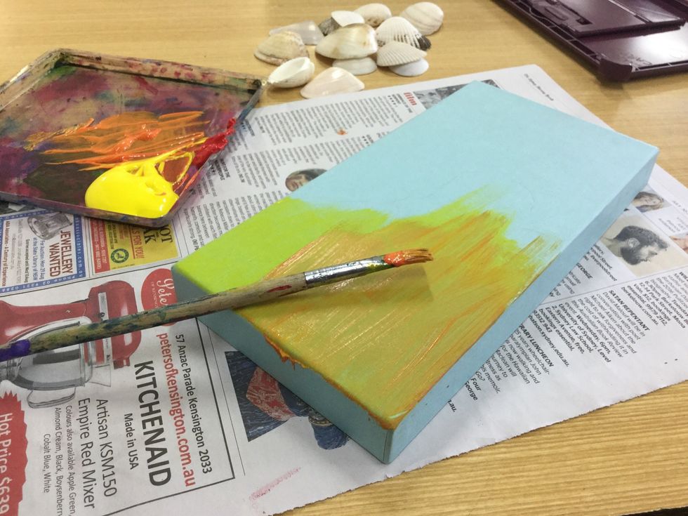 Start painting on your sand.First I did a coat of yellow, as a base.Then I went over it with a light orange.Make sure you do several layers.