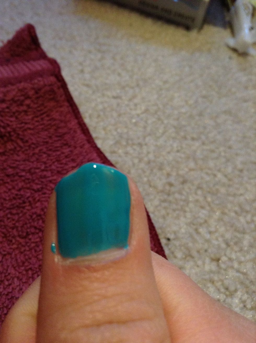 Start painting the plain color you chose to add on top of the nail