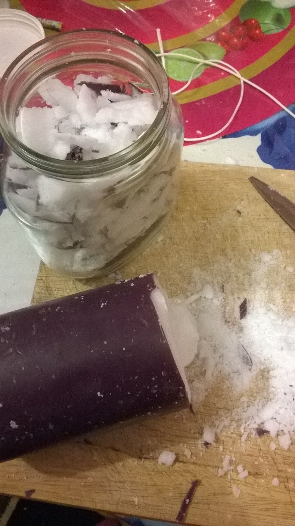 Start placing bits of the wax into your jar. As you can see there is a lot of the candle left, don't worry a lot more of it will go in when the wax starts to melt.