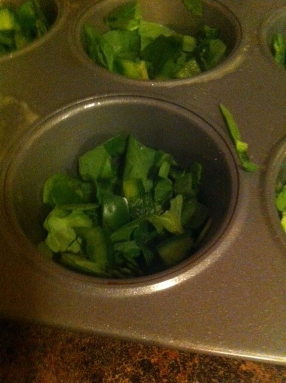Start prepping your muffin cups. I will not lie -this part is slightly labor intensive. Place spinach in muffin cups so it may act as a 'crust' of sorts.  *I started adding the green peppers