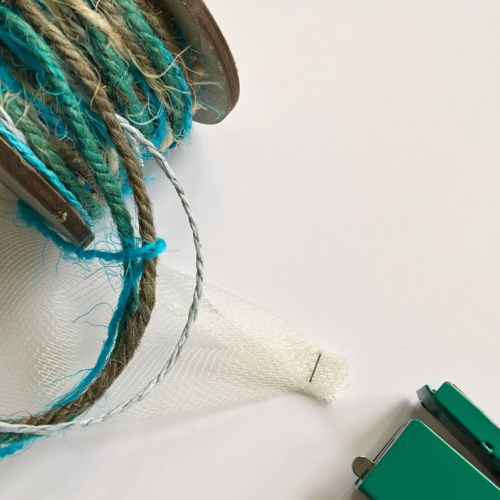 Start putting a clip on the ribbon so you'll glue it easily, then tie cord on the ribbon each 2\u201d or 2 \u00bd \u201c  to keep it together.