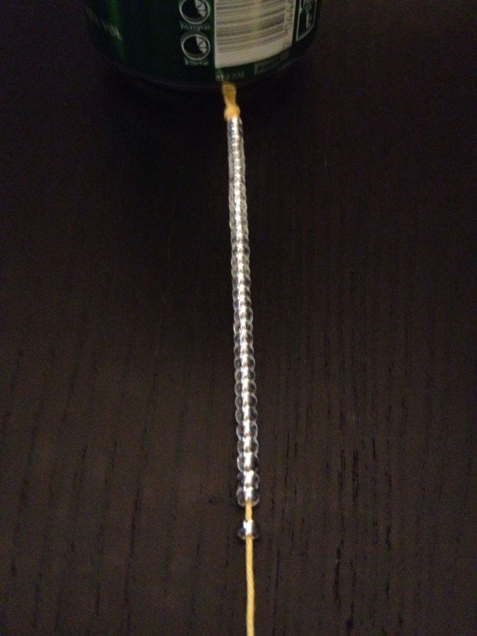 Start putting breads on The thread, like this. Lots of them. Ajust according to Your arm.