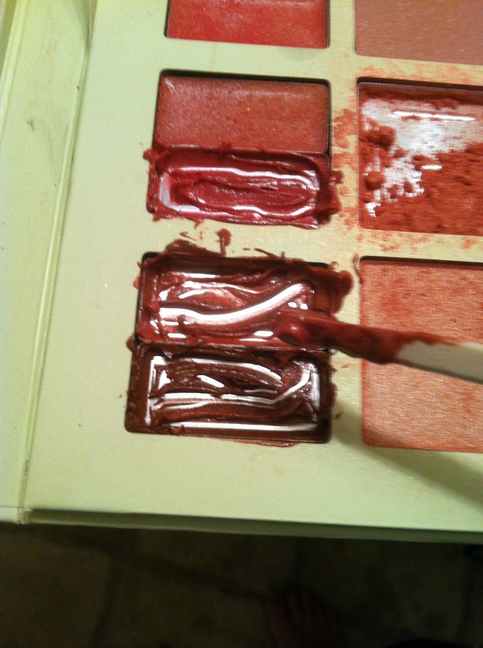 Start scraping out lipgloss into the container you chose