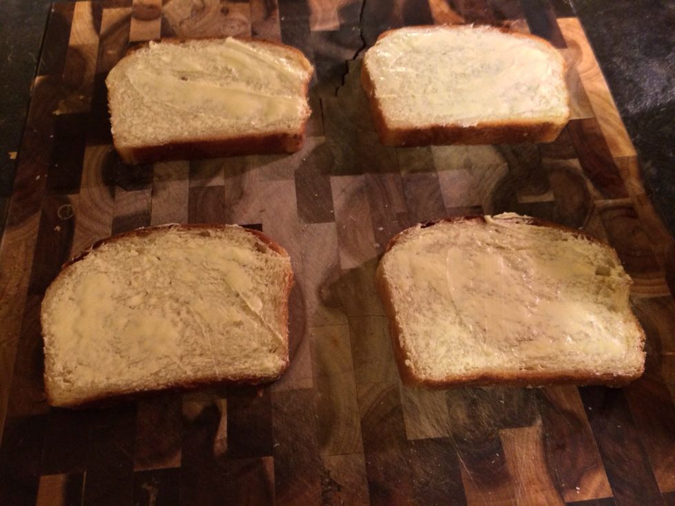 Start spreading a good layer of butter on all slices. This will add a rich flavor to our sandwiches and helps brown the bread on the grill.