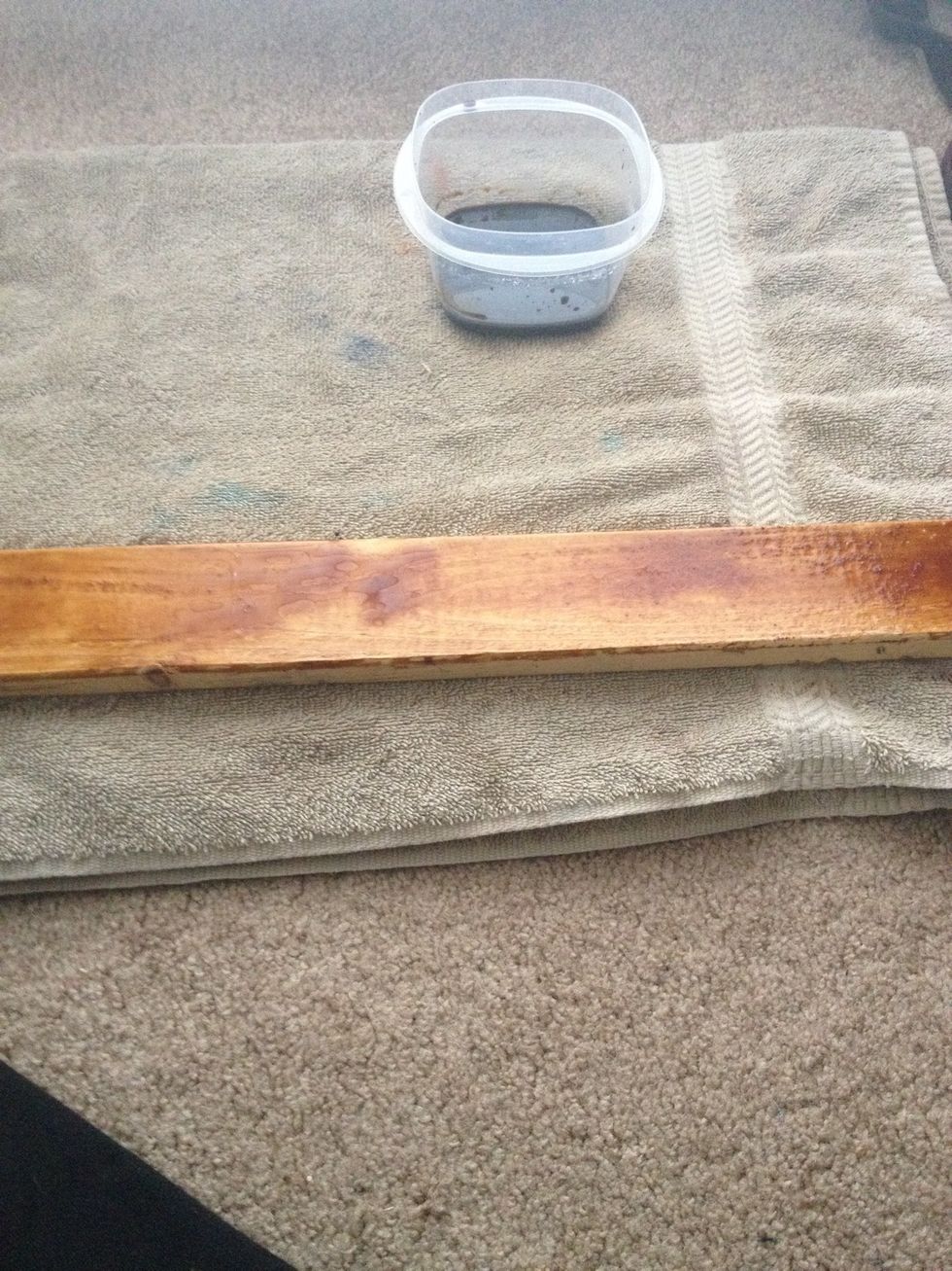 Start staining the wood. If the soy sauce has small holes, just put on more soy sauce and brush it in.