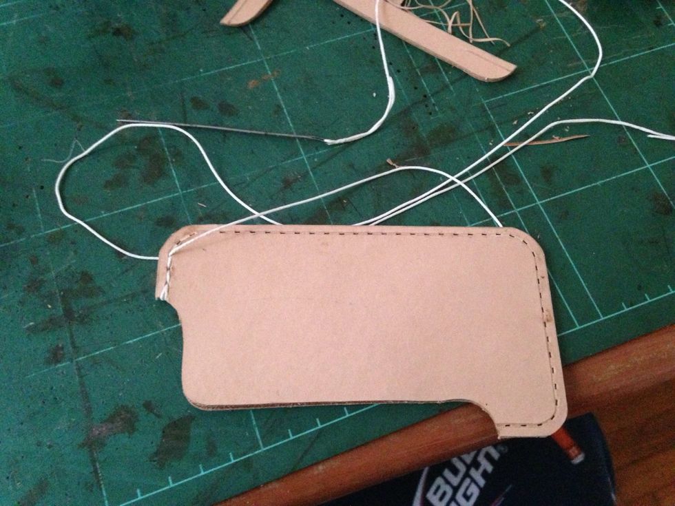 Start stitching from the top of the case.. Make a double loop on the begining and the end of the stitching