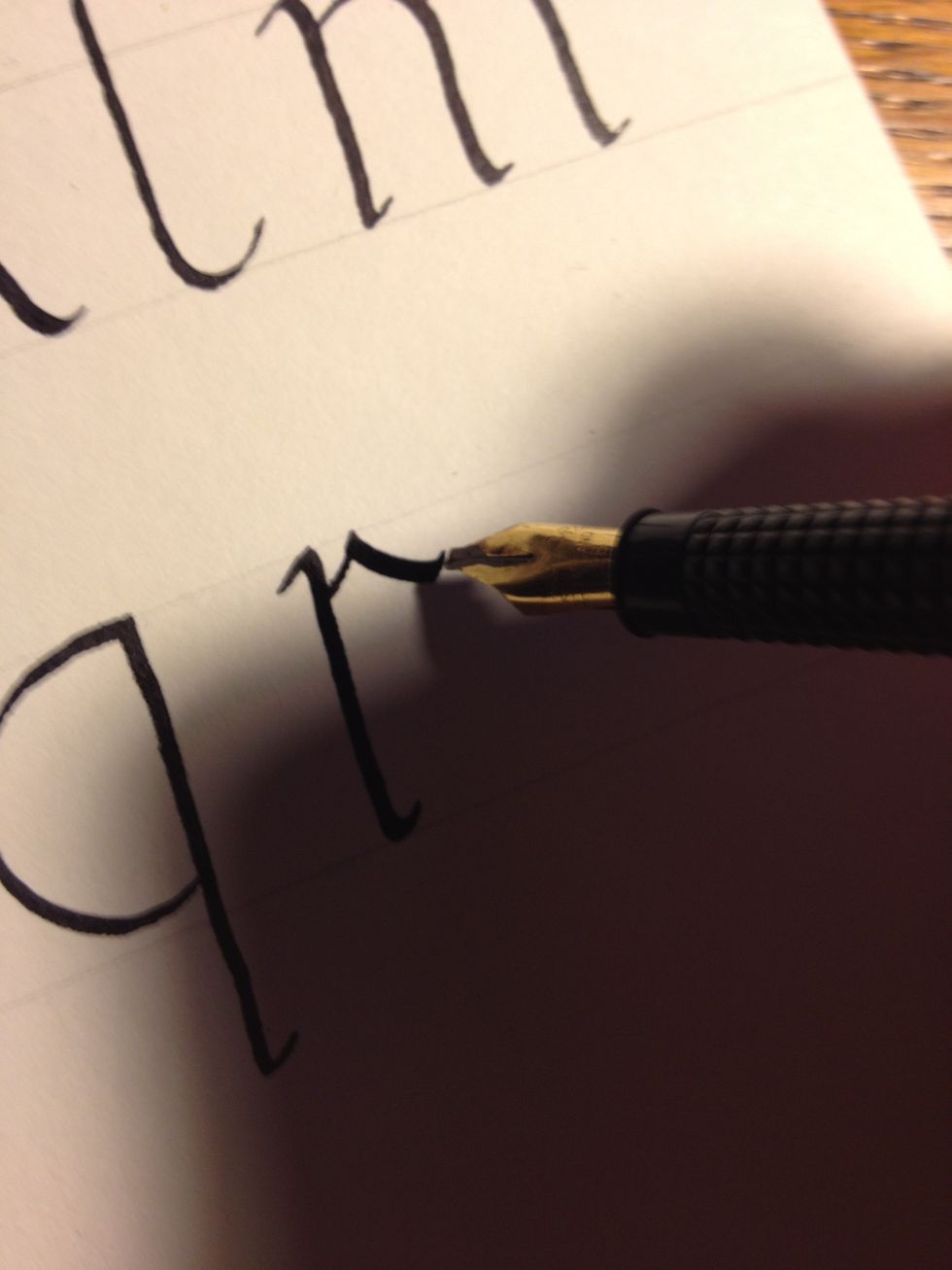 Start the second stroke near the top of the trunk. Make a slightly curved thin line to the top line, then a slightly curved thick line downwards. Flare up at the end to make it look extra classy.