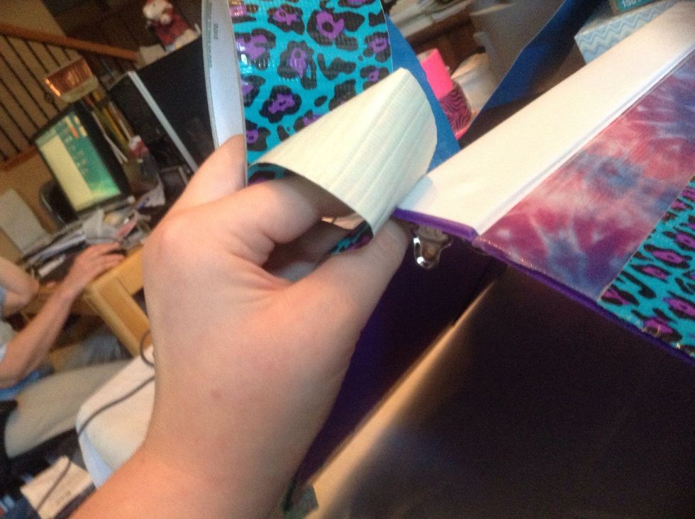 Start the tape on one edge, leaving extra tape, and follow the markings. Fold the binder a little when you come to the binding together it in the crevices.