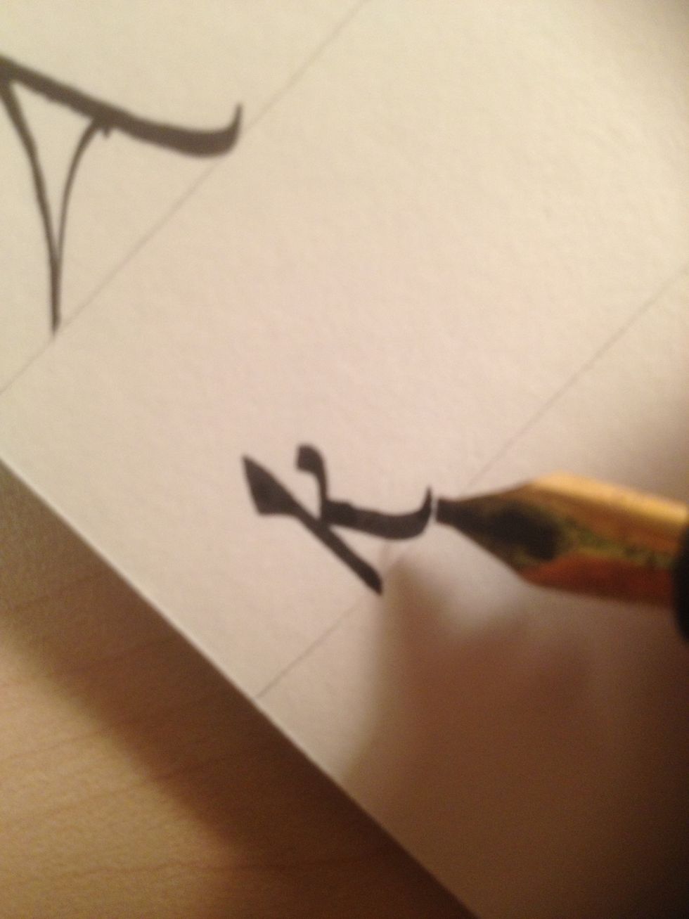 Start the third stroke at the base of the second stroke, curving it back up as it reaches the bottom line.