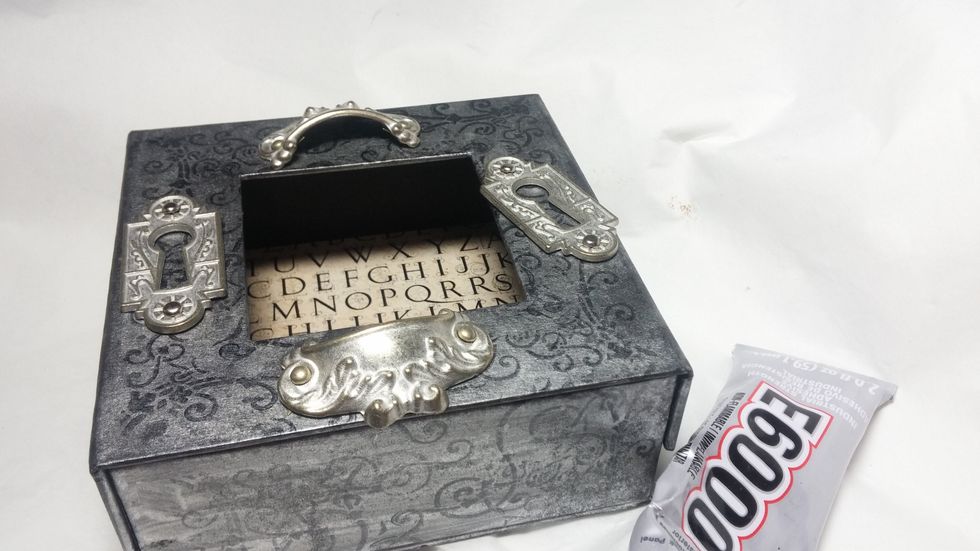 Start to audition your metal embellishments. I never know exactly how something will come out until the end! I use a very heavy glue to ensure that everything will stay in place.