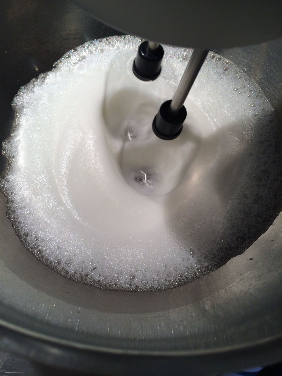 Start to beat the egg whites on medium speed