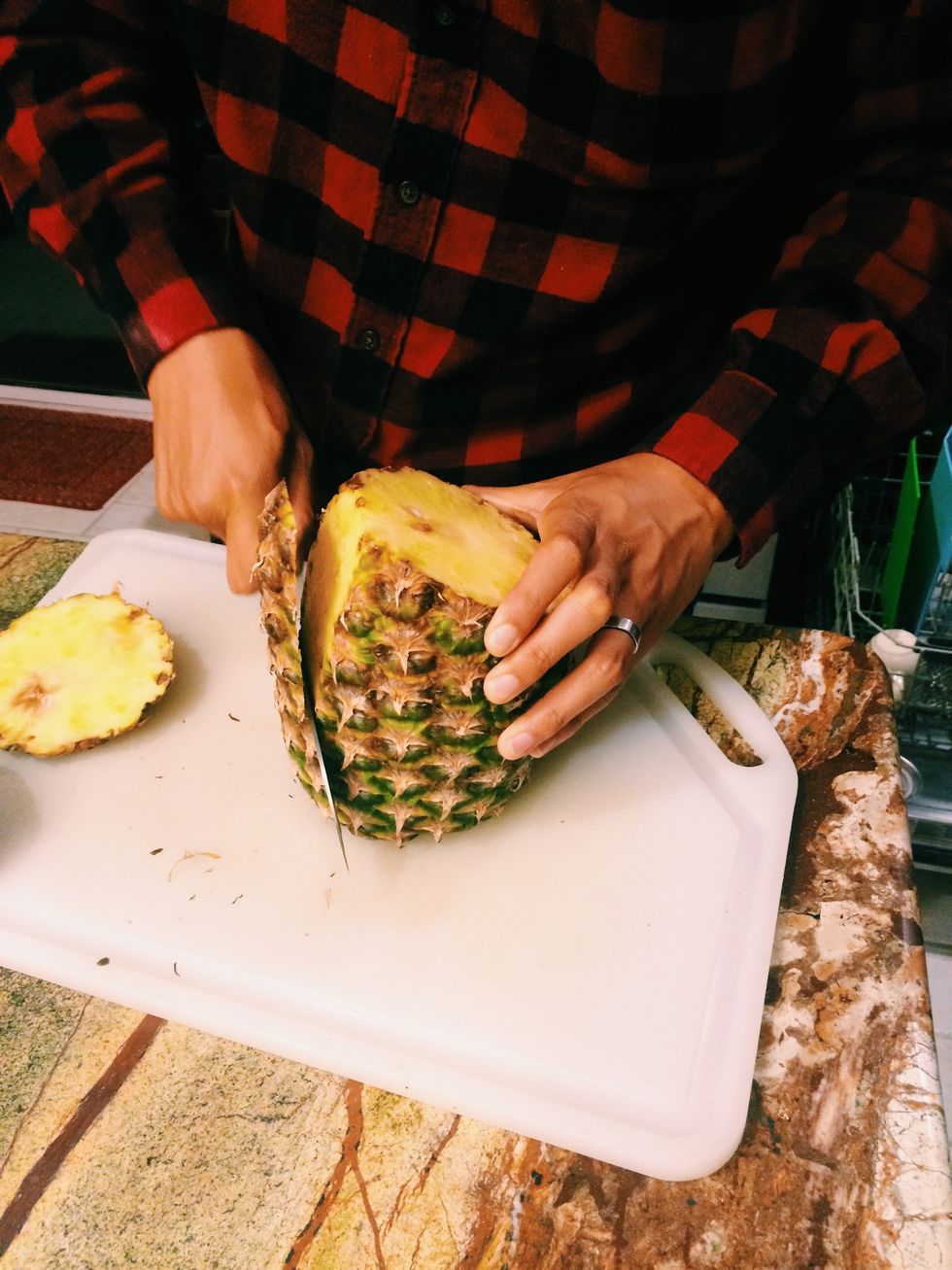 Start to cut off skin of pineapple