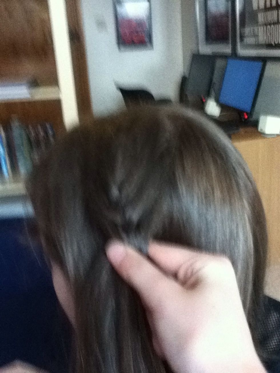 Start to French braid in a vertical line down your head.