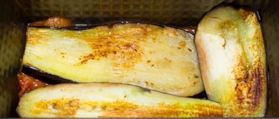 Start to layer the sauce, eggplant and cheese