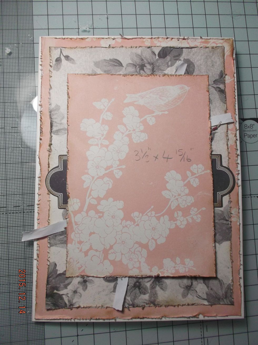Start to layer up the papers, largest first. Tuck under the matching ends of ephemera.