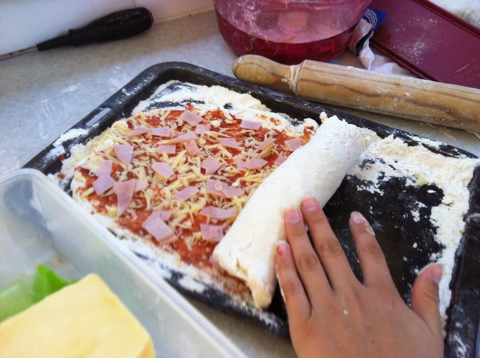 Start to roll up your pizza starting from the bottom