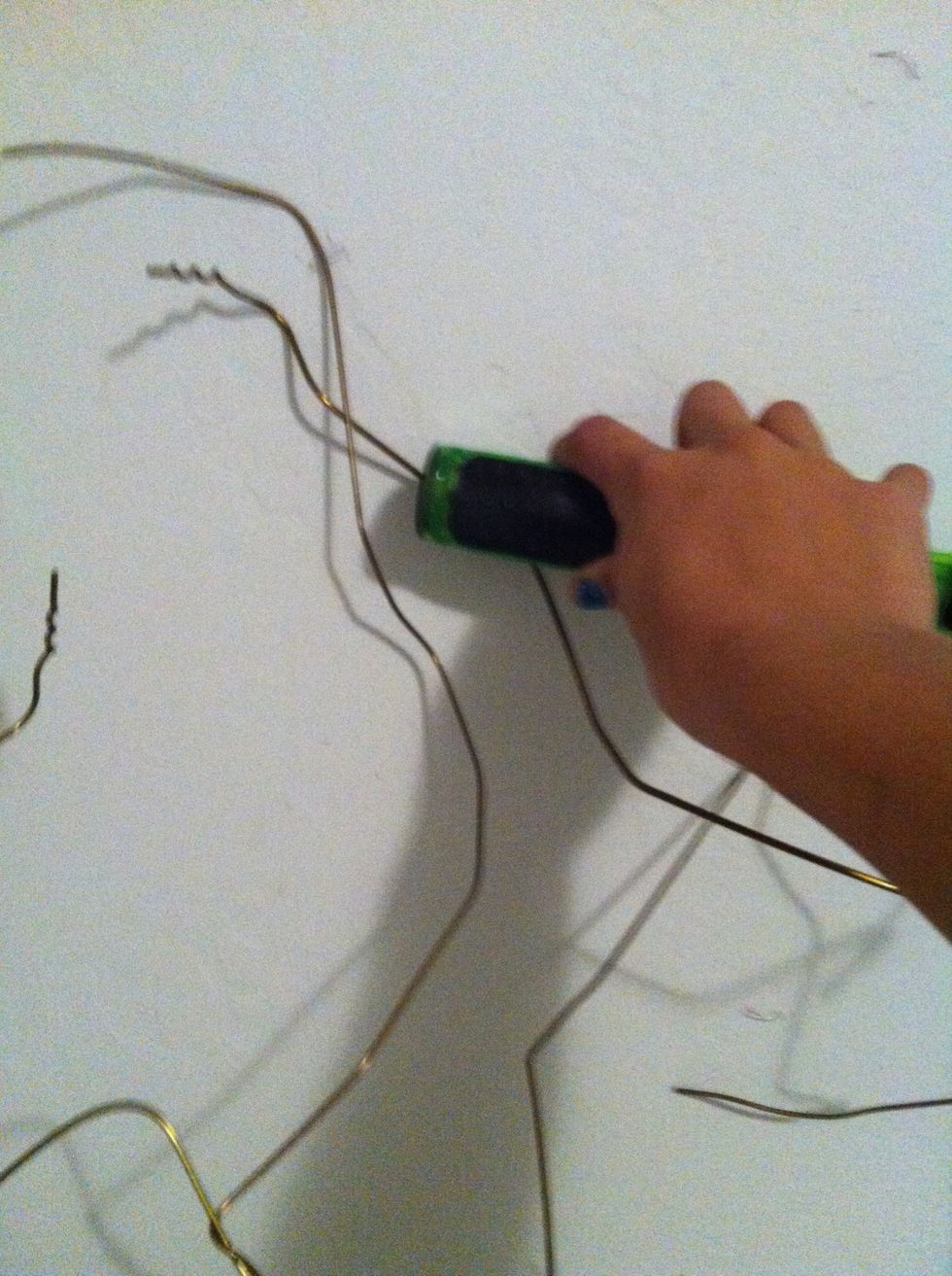 Start to staple the wire on the wall. You can no longer shape the wire. You may want to use a hammer to reinforce the staples. Remember the more staples the stronger.