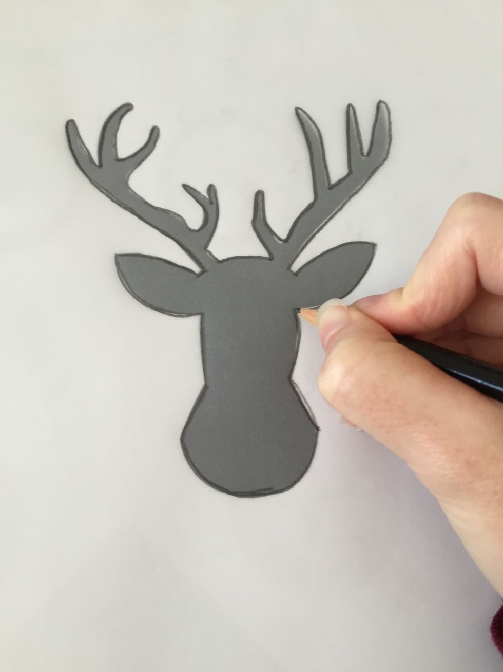 Start tracing the outline of the deer.
