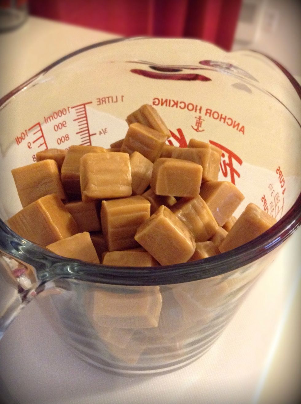 Start unwrapping all of the caramel squares and place them in your measuring cup. Yes I know its a pain in the butt to unwrap all of those little squares but its TOTALLY worth it!!