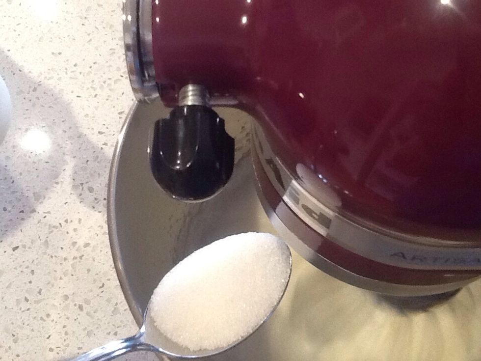 Start whisking again on a higher speed and slowly add sugar spoonful at a time.
