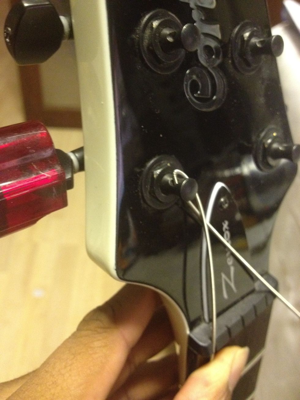 Start winding the string using the tool/hand.  Strat-head: Turn the pegs AWAY from you Les-head: top 3 pegs AWAY, bottom 3 pegs TOWARDS you