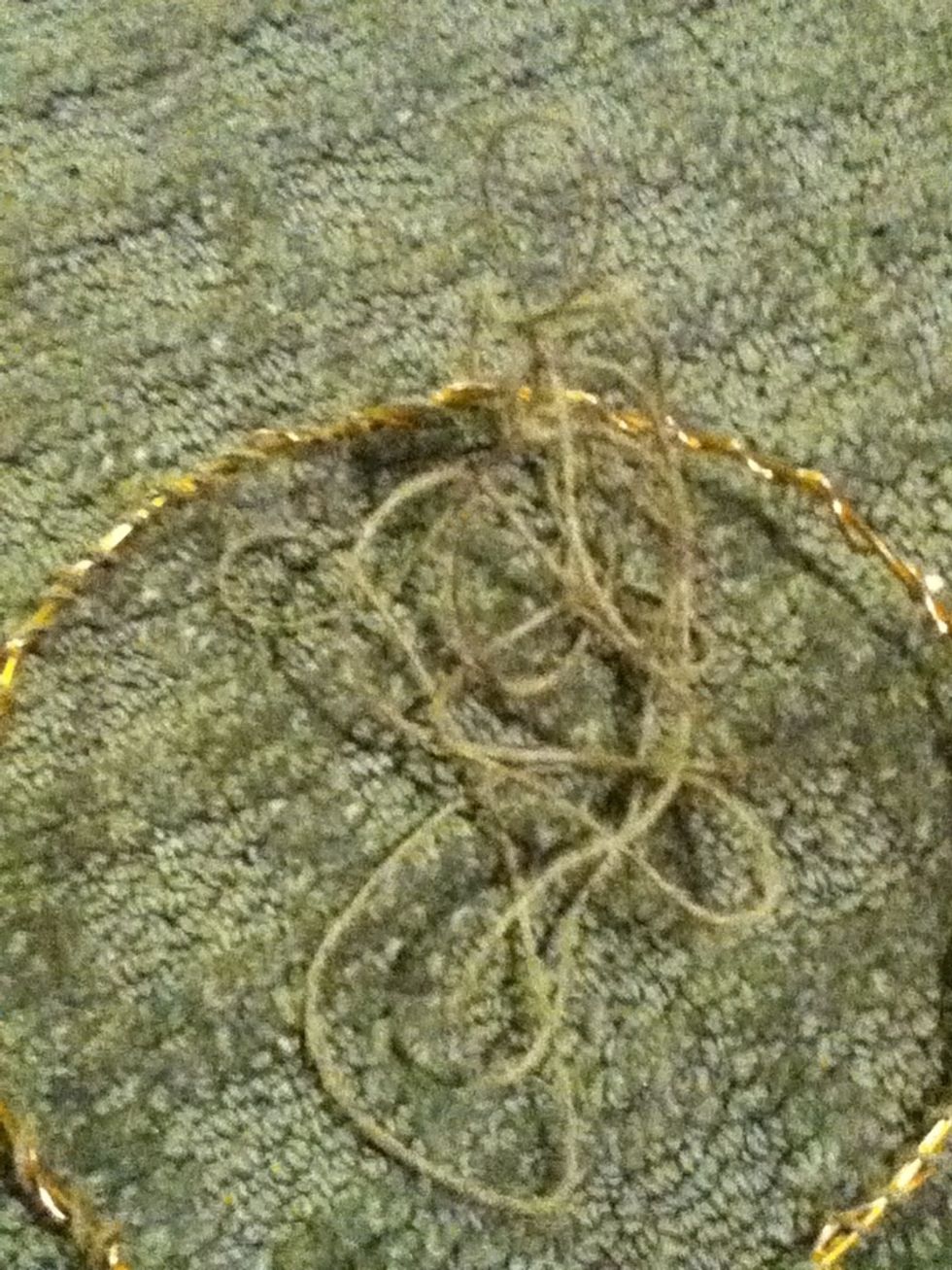 Start winding the twine or string around the metal ring. Make sure to keep the string loose, as you will need room in following steps.