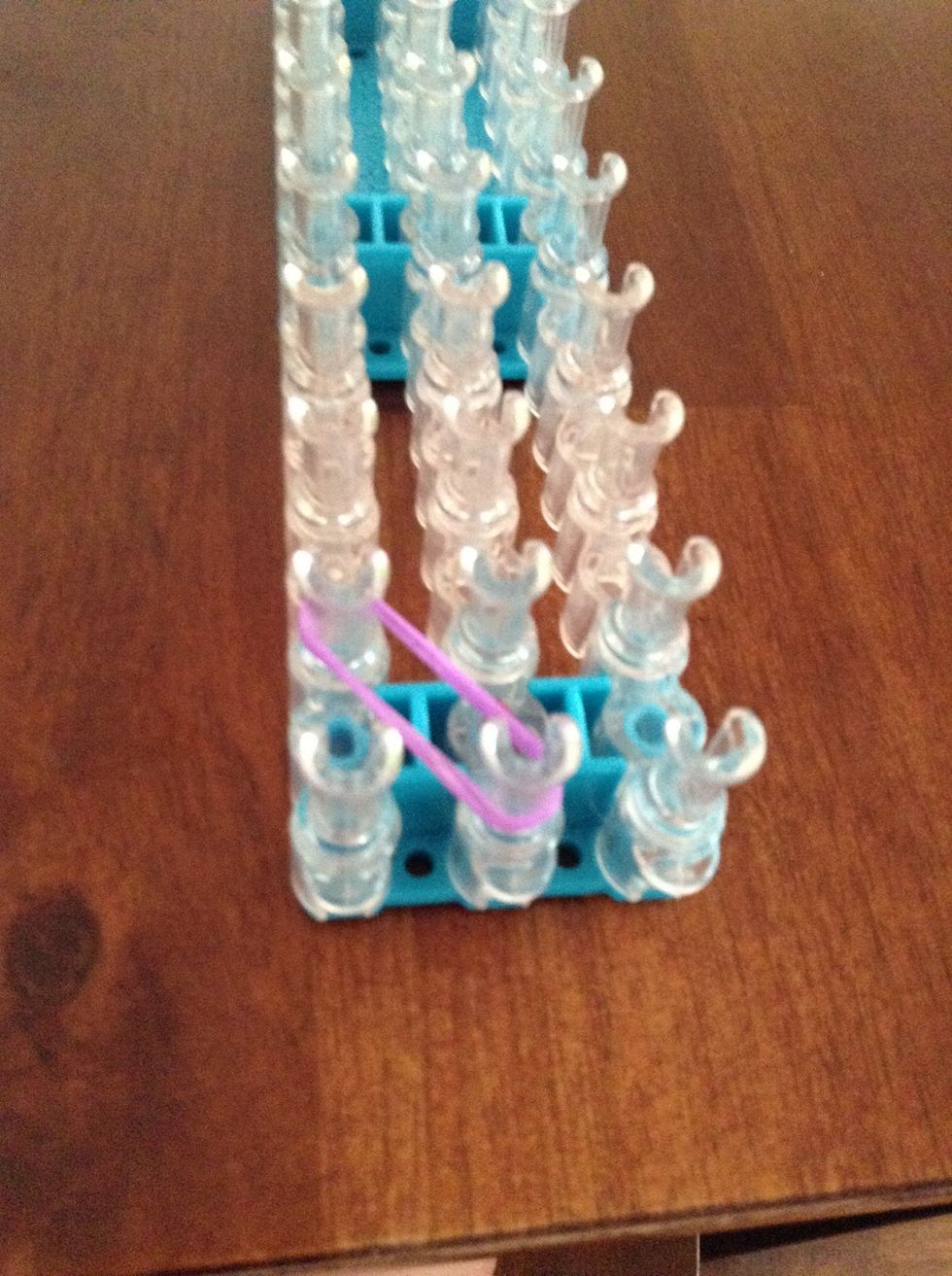 Start with 2 bands going from the center peg to the left peg.