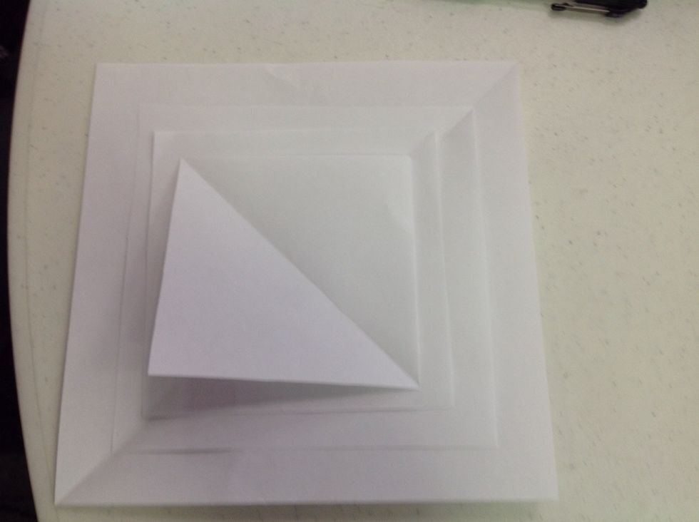 Start with 4 square pieces of paper of various sizes.