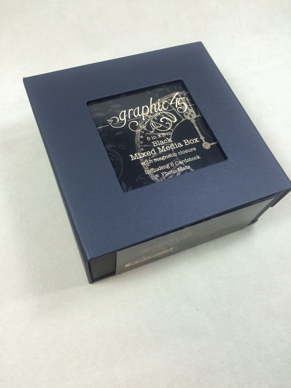 Start with a 5" x 5" black mixed media box from Graphic 45. Inside the box come six black cardstock squares.