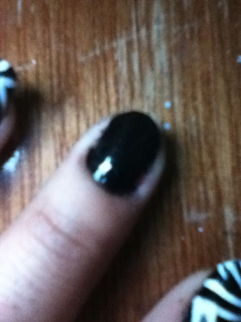 Start with a base coat to protect your nails Apply two coats of a black polish all over your nails