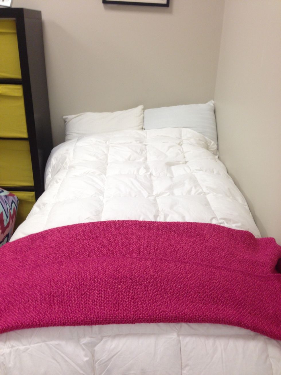 Start with a bright colored throw blanket for the end of the bed