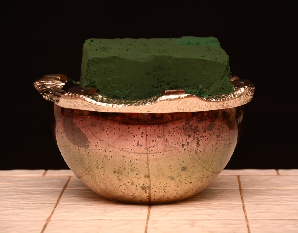 Start with a container. This is going to be an upscale design for your dining room table or perhaps a party or event, so pick a nice container. Not a small one either. Fill with floral foam.