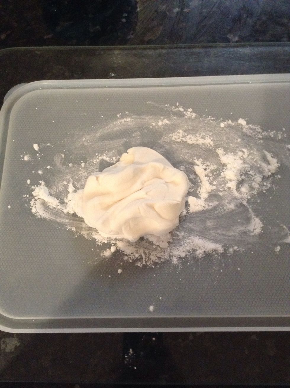 Start with a handful of white moulding icing placed on a board covered in corn flour (for non-sticking purposes)