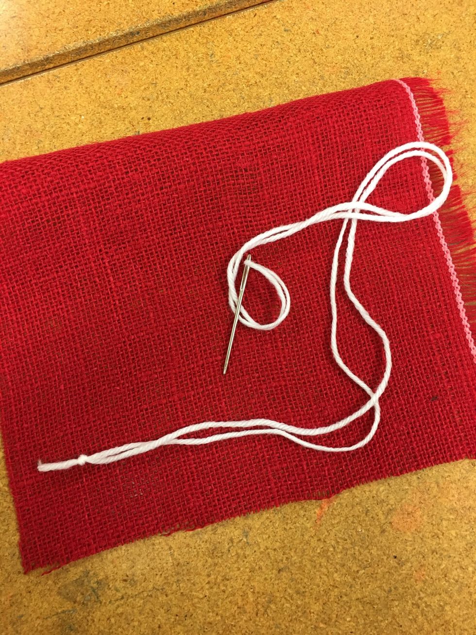 Start with a piece of yarn threaded on your needle and knotted.