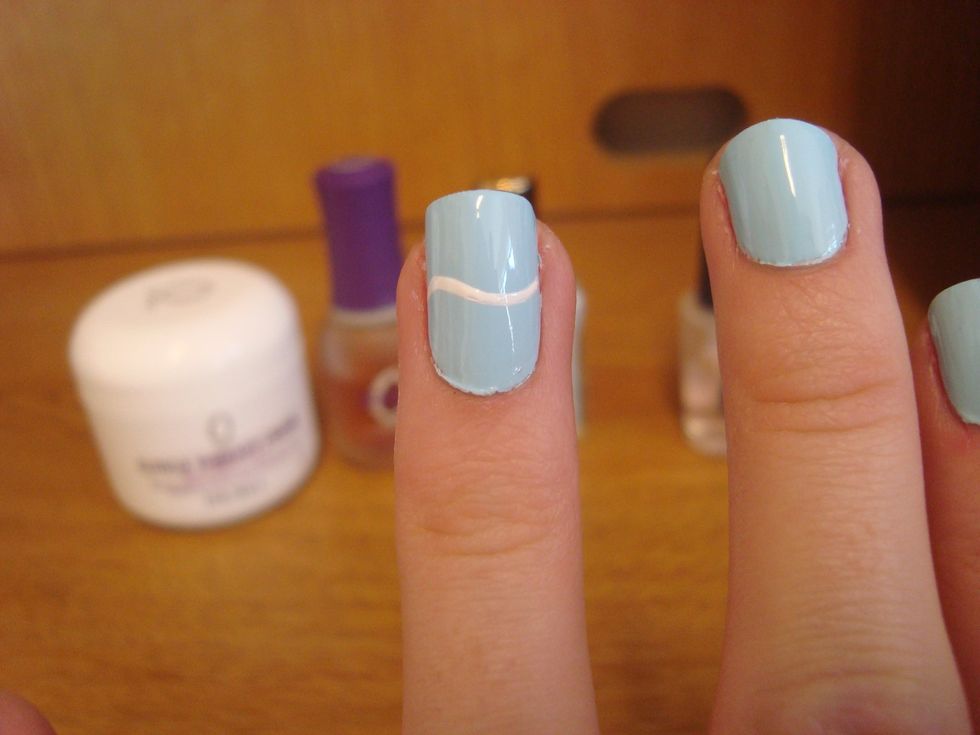 Start with a squiggle line across the center of one nail. You can do all, I just prefer one.
