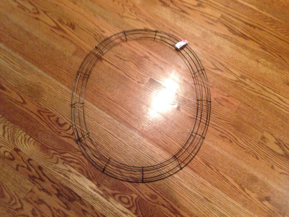 Start with a wire work wreath.  You can also use a grapevine wreath, which is the woodsy kind.  This wreath is bendable so I just pushed the sides in to make it oblong.