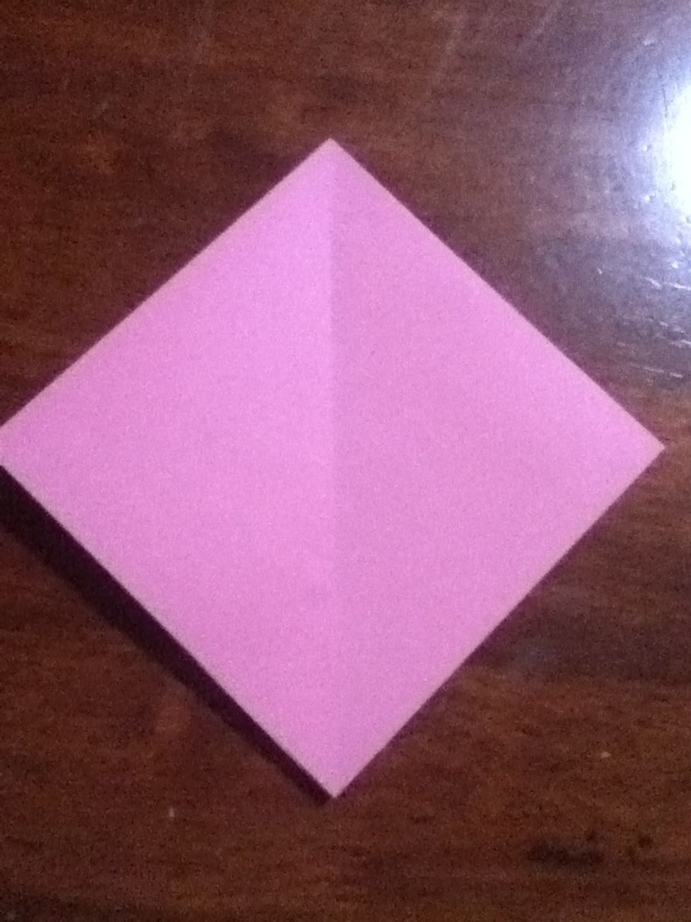 Start with an origami preliminary base, I have a guide for that so don't worry if you don't know how to make one ;) Arrange it so that the open end is facing you