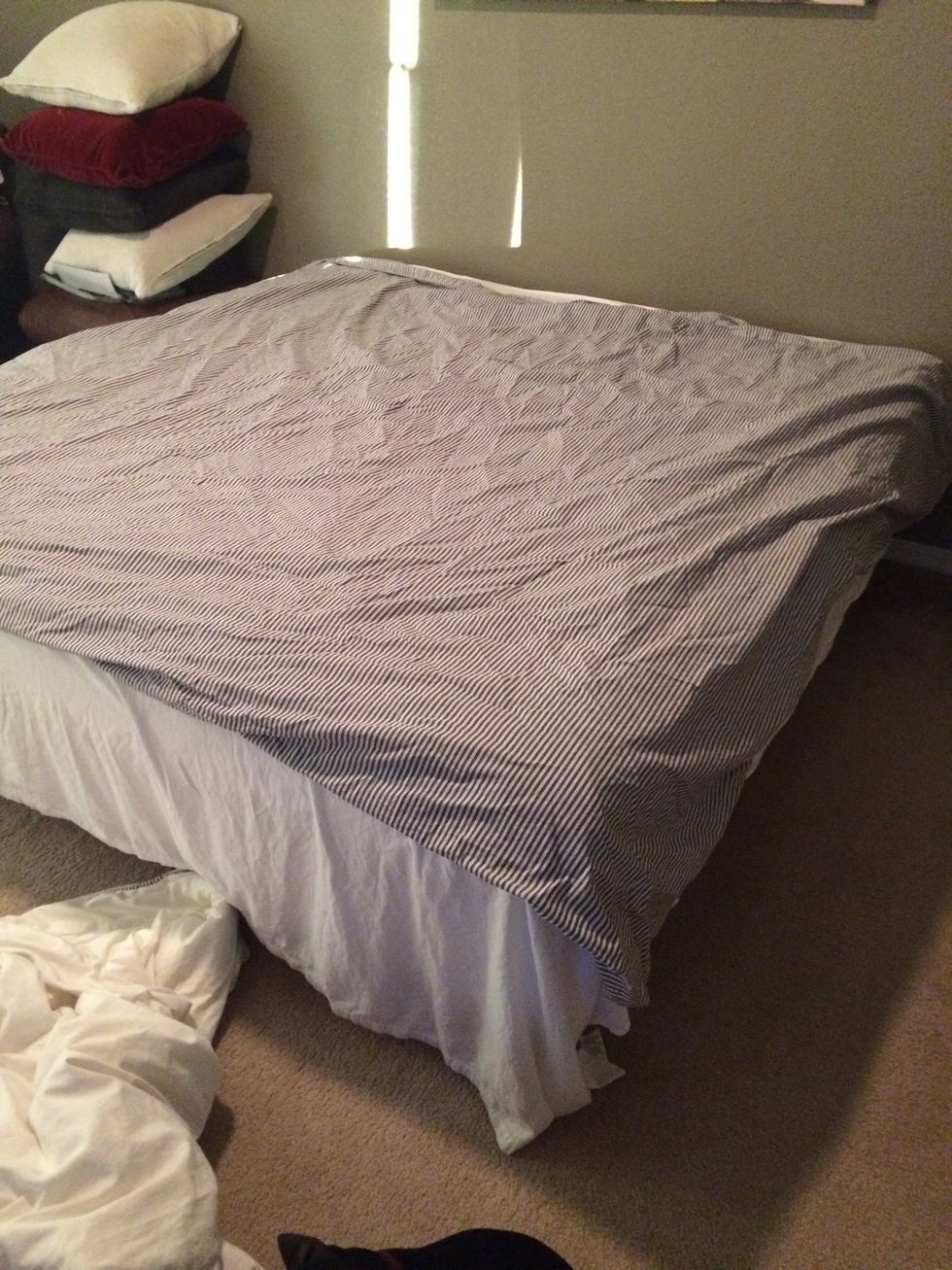 Start with duvet cover inside out on the bed (or floor) with the opening at the top.