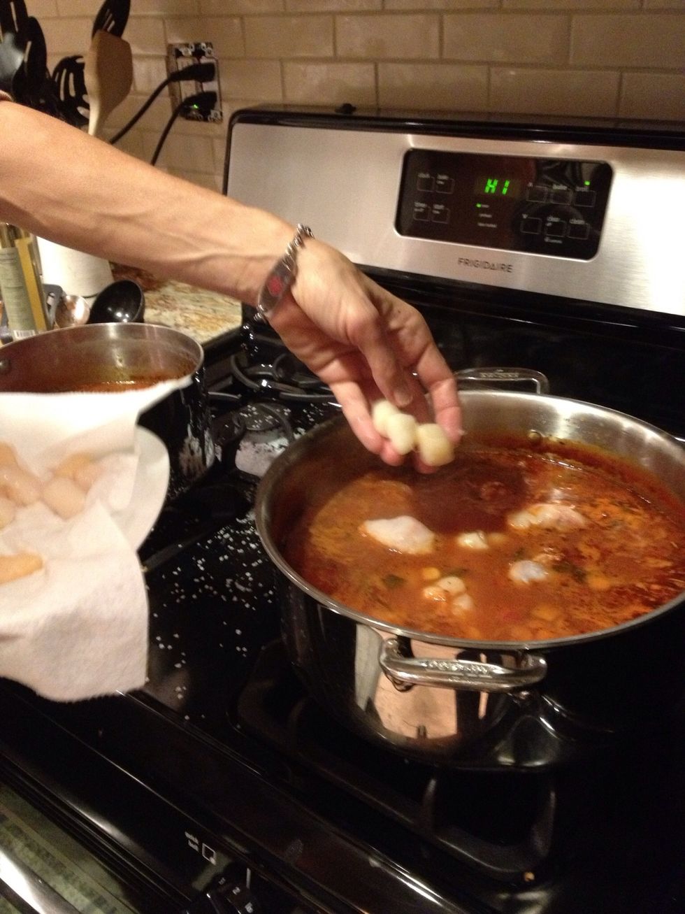 Start with fish then few minutes later add the scallops and shrimp followed by the shellfish.