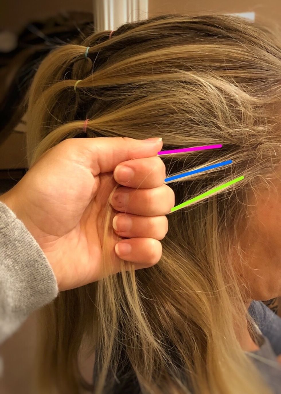 Start with one section, gather a small amount of hair and separate it into 3 pieces.