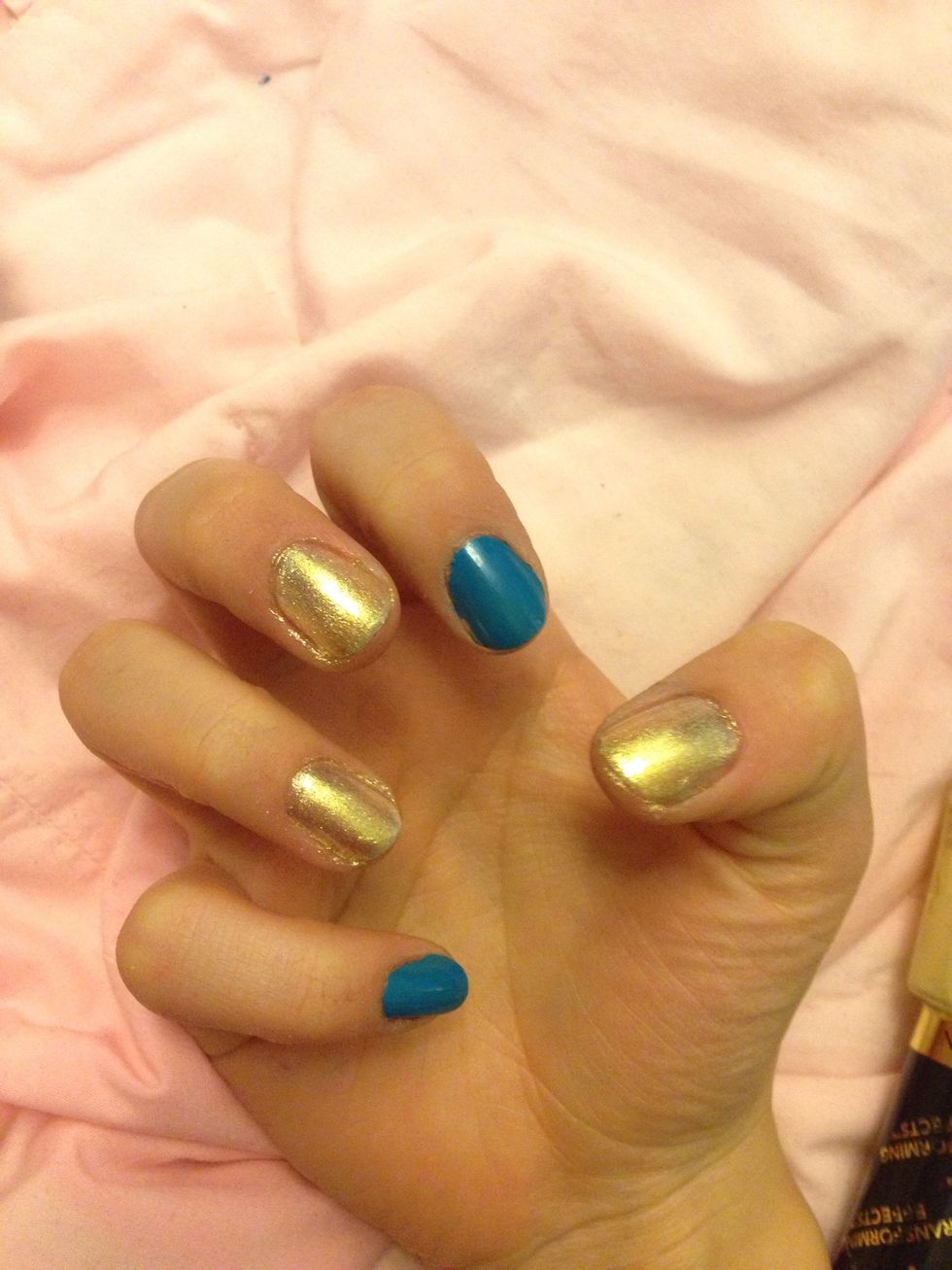 Start with painting your pointer finger& pinky finger blue. Then the other 3 gold