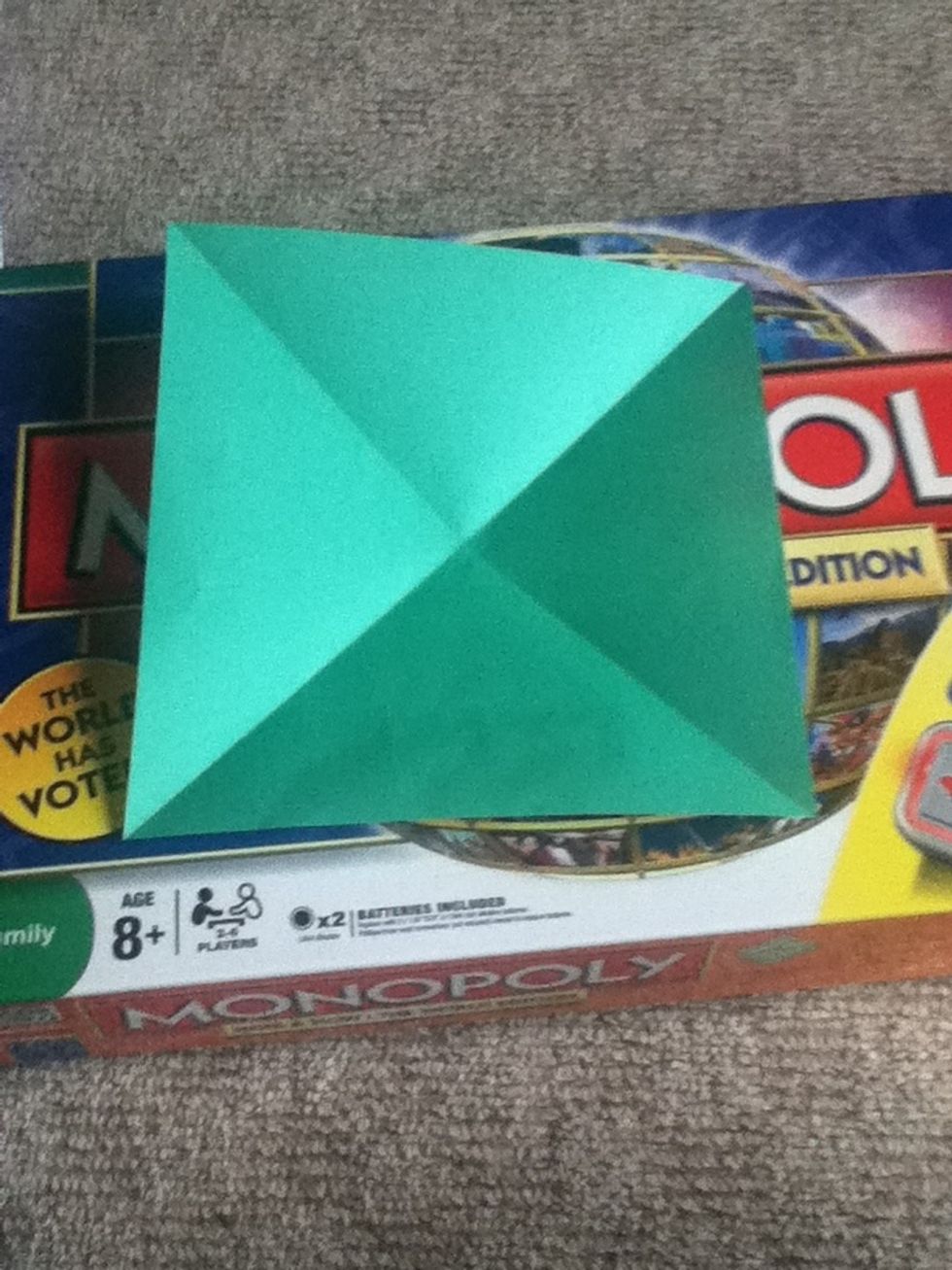 Start with the coloured side up. Fold diagonals and turn over