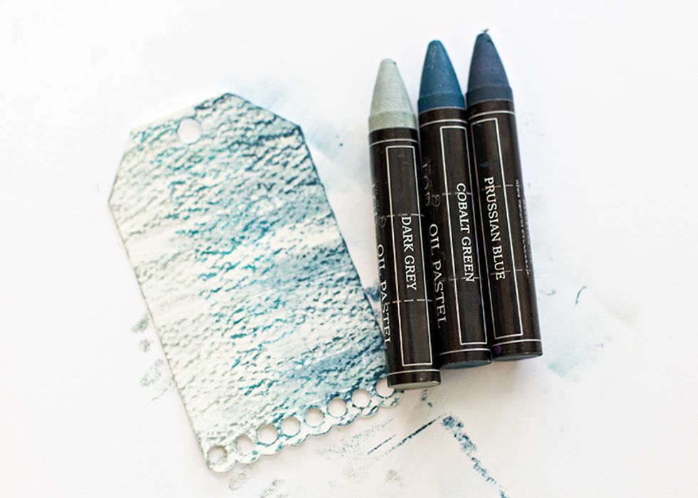 Start with the darkest color (Prussian blue), scribbling it on the side. Next add Cobalt Green in the middle, and lastly, add Dark Grey. Blend with your finger.