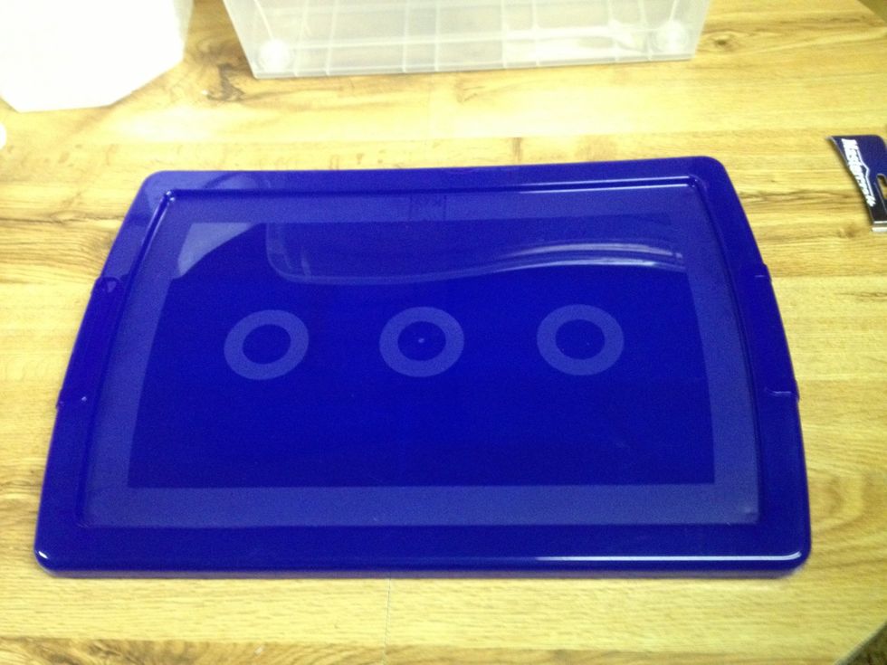 Start with the lid to your tub. We are going to cut a hole slightly smaller than the diameter of the funnel. Careful not to make it too big or the lid is ruined