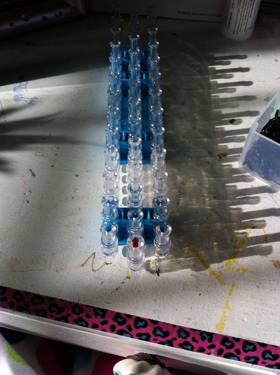 Start with the loom placed this way and the arrows facing away from you