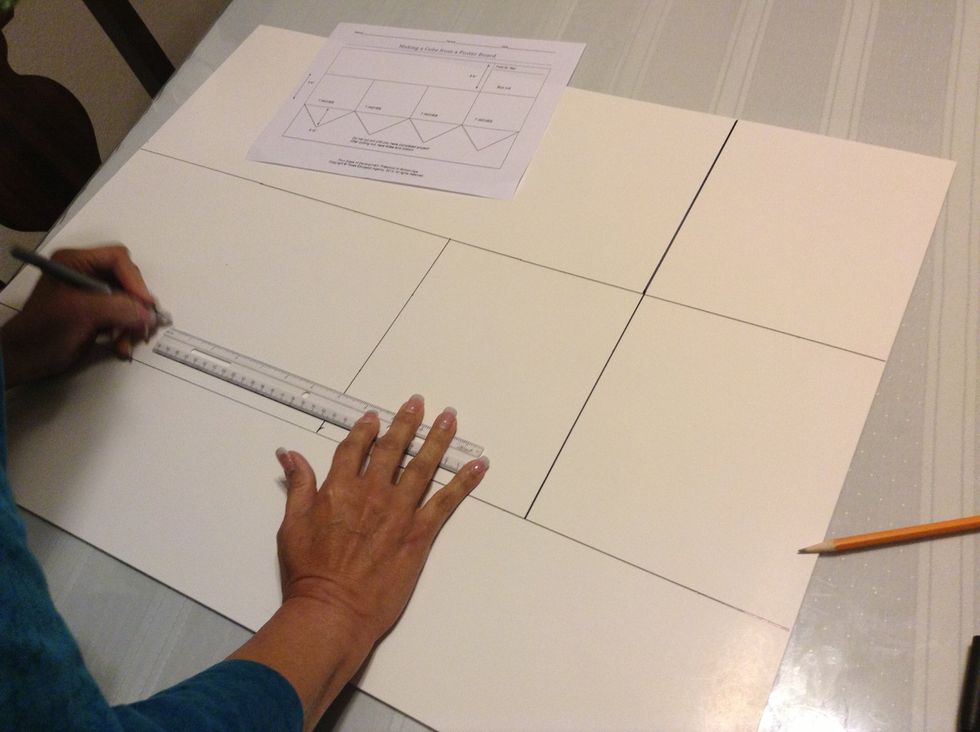Start with the right edge of the poster board and measure and mark 7 inches. Continue until you have drawn 4 boxes 8 3/4 x 7 inches each. Add a box to the top line as shown on the handout.