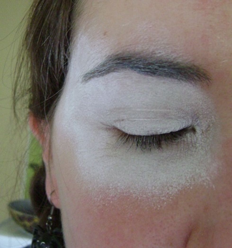 Start with the sponge to apply the white base around eyes.