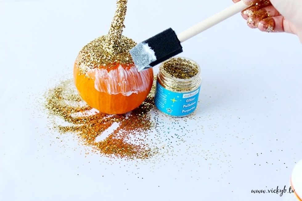 Start with the top section first and work your way around the pumpkin. Remember, glitter will only go where you apply the glue.
