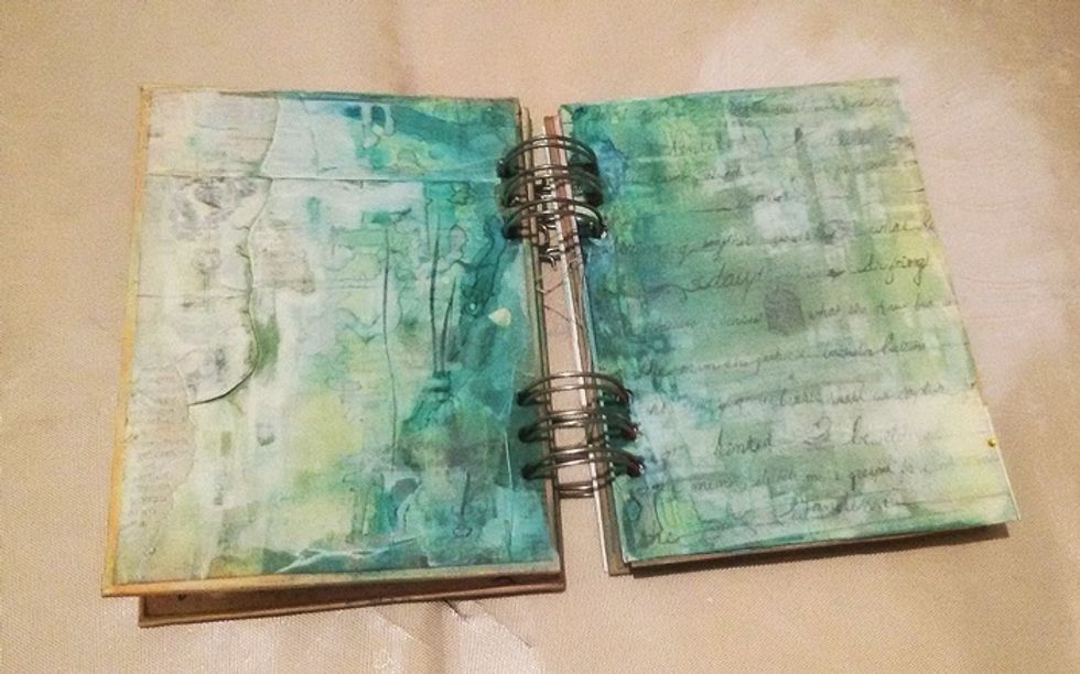Start with two pages.I don't remember when I started painting this, but I know I applied some white gesso on Prima Epiphany paper & added some Peacock Feathers, Studio Blue, & Glorious AA Mists.