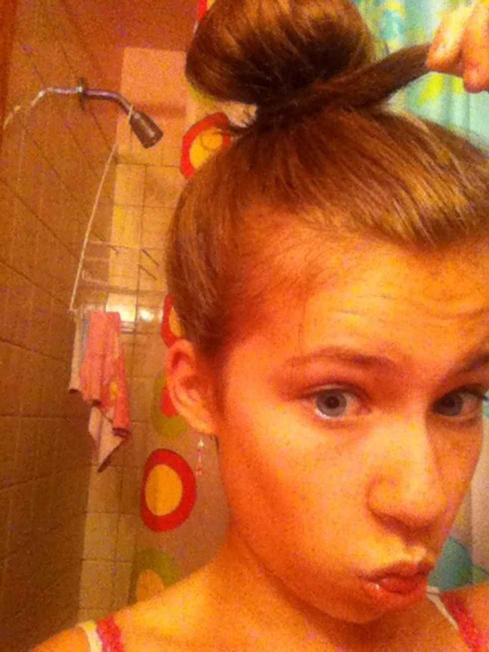 Start with your hair like this. In a bun at the top of your head, with one section of hair sticking out at the front.